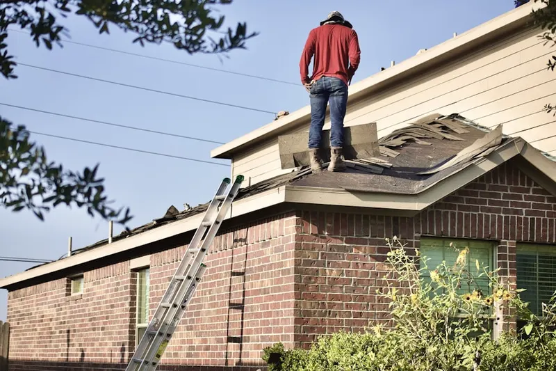 Professional roofer working on a residential roof in Lytle